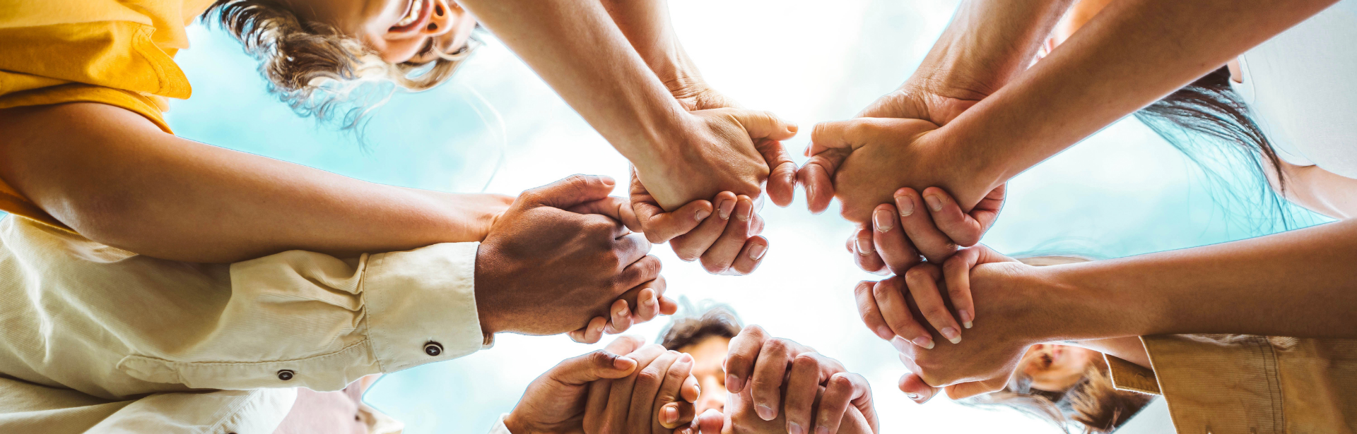 group of people holding hands in center